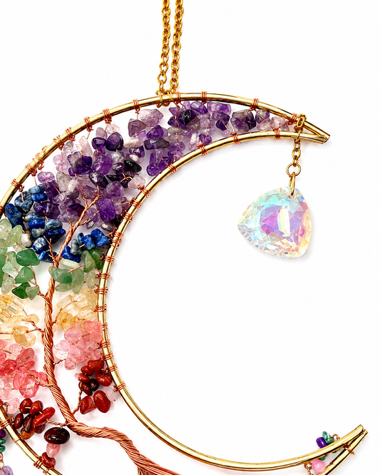 A gold crescent moon and tree of life dream catcher featuring multicolored gemstone clusters and an iridescent teardrop crystal prism, shown on a white background.