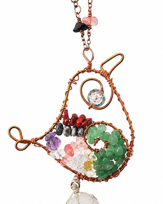 A handmade wire-wrapped crystal hanging home decoration featuring a spiral design with various colored gemstones including green, pink, purple, red, black, and clear crystals, suspended from a copper chain on a white background.