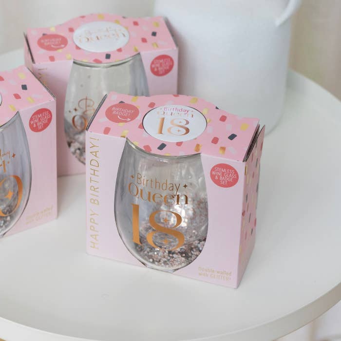 Celebration 18th Glitter Stemless Glass & Badge Set by Splosh in a styled birthday display