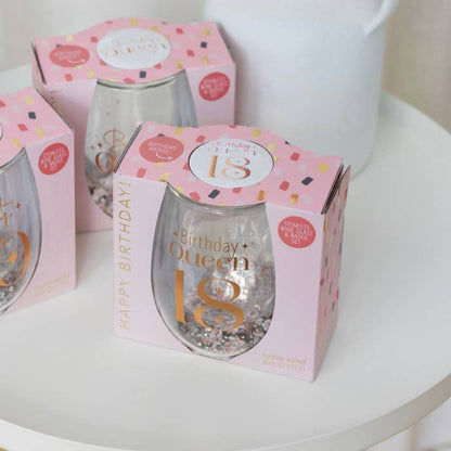 Celebration 18th Glitter Stemless Glass & Badge Set by Splosh in a styled birthday display