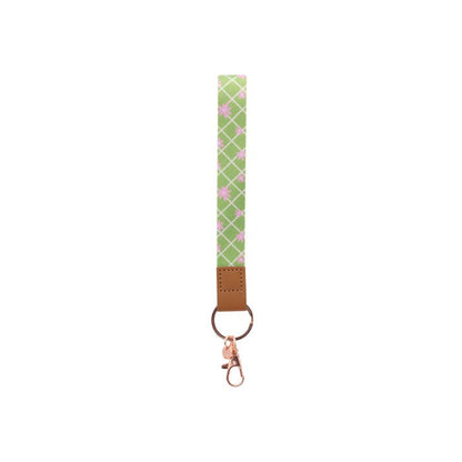 Teacher Green Daisy Fabric Wristlet Keychain by Splosh showing the wrist loop and clip