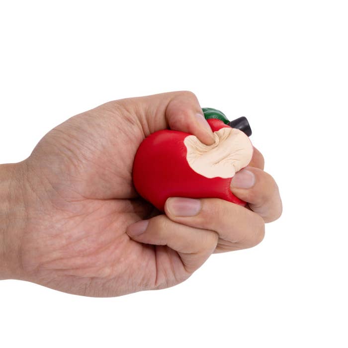 Teacher Apple Stressball by Splosh being squeezed in a hand