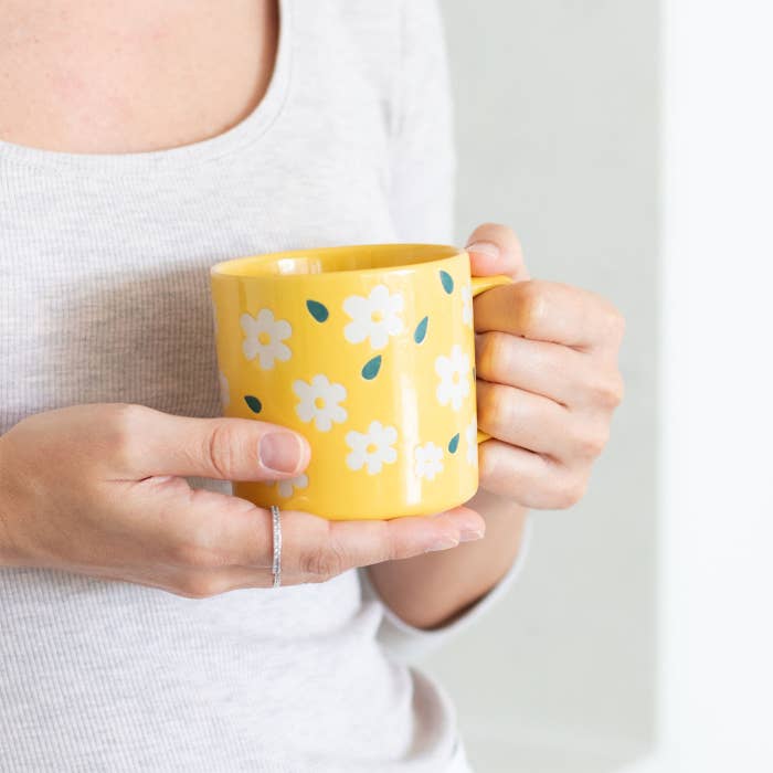 Teacher Flowers Mug by Splosh held in a hand