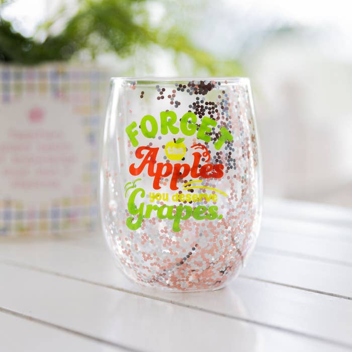 Teacher Grapes Glitter Wine Glass by Splosh in a styled glassware display