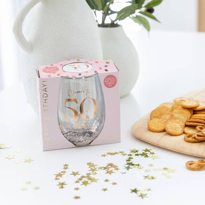 Celebration 50th Glitter Stemless Glass & Badge Set by Splosh in a styled birthday setting