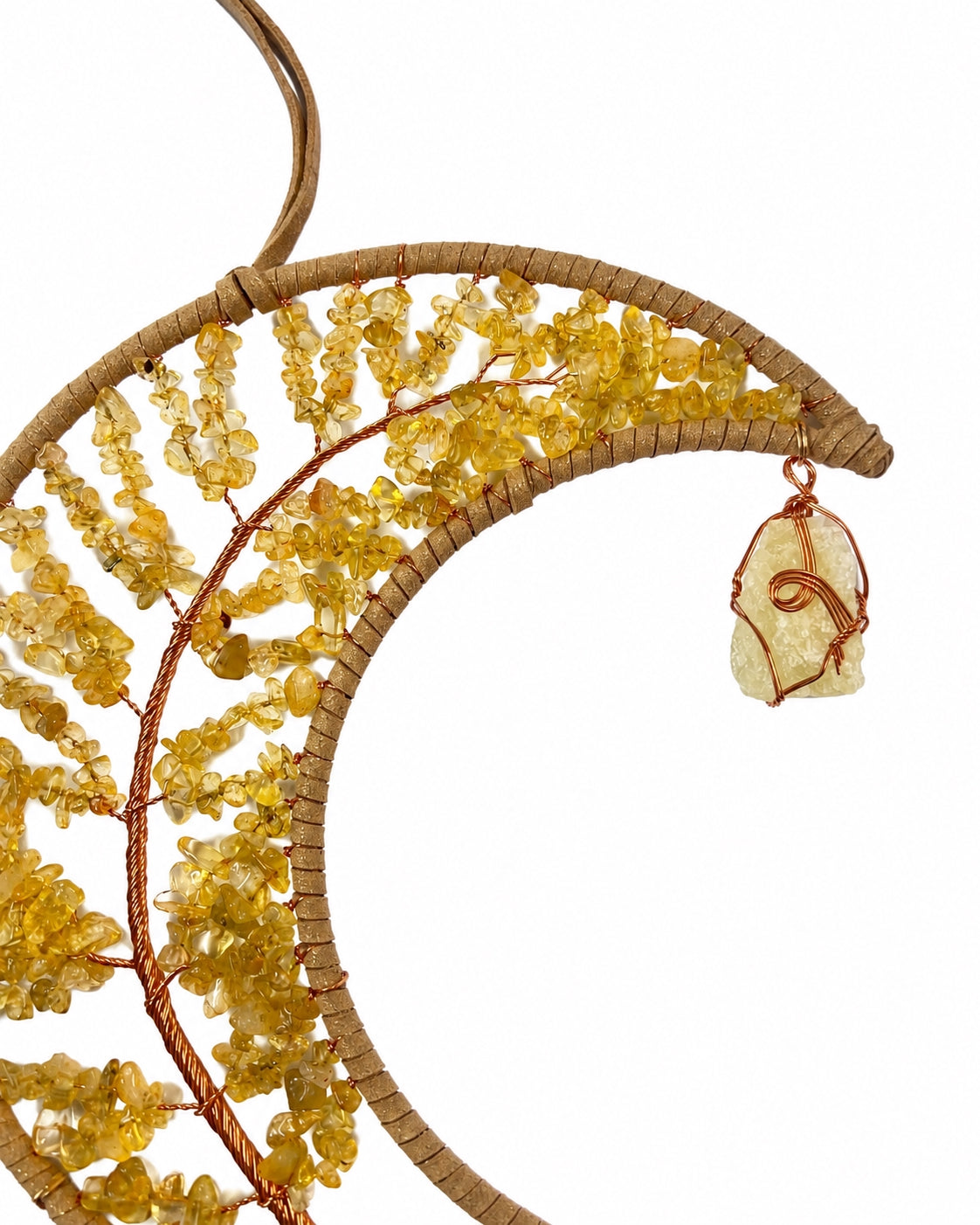 Close-up of a golden crescent moon dream catcher handcrafted with warm natural crystal chips, copper wire and tree of life details.