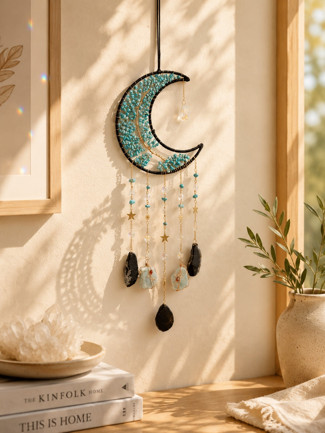 Turquoise crescent moon crystal dream catcher hanging in a warm sunlit room as a distinctive piece of boho home decor.