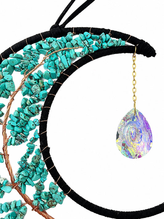 Close-up of a turquoise crescent moon dream catcher handcrafted with natural crystal chips and a faceted rainbow crystal ball.