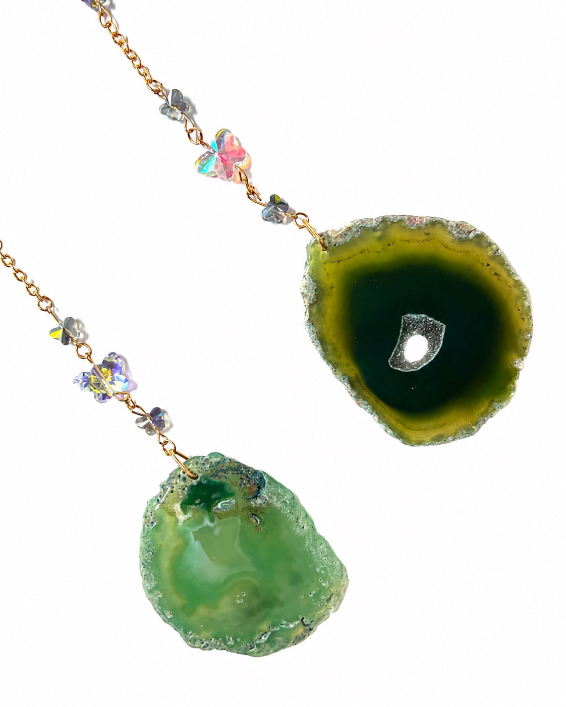 Close-up of vibrant green natural agate slice pendants and gemstone bead details from a crescent moon crystal dream catcher.