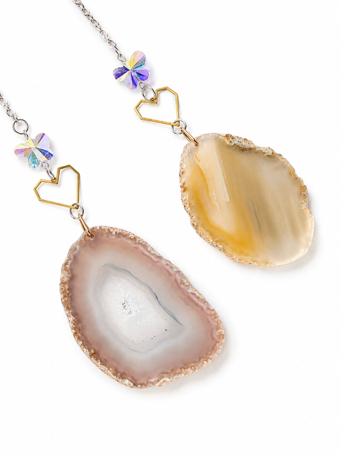 Close-up of translucent natural agate slice pendants and delicate gemstone beads hanging from a crescent moon crystal dream catcher.