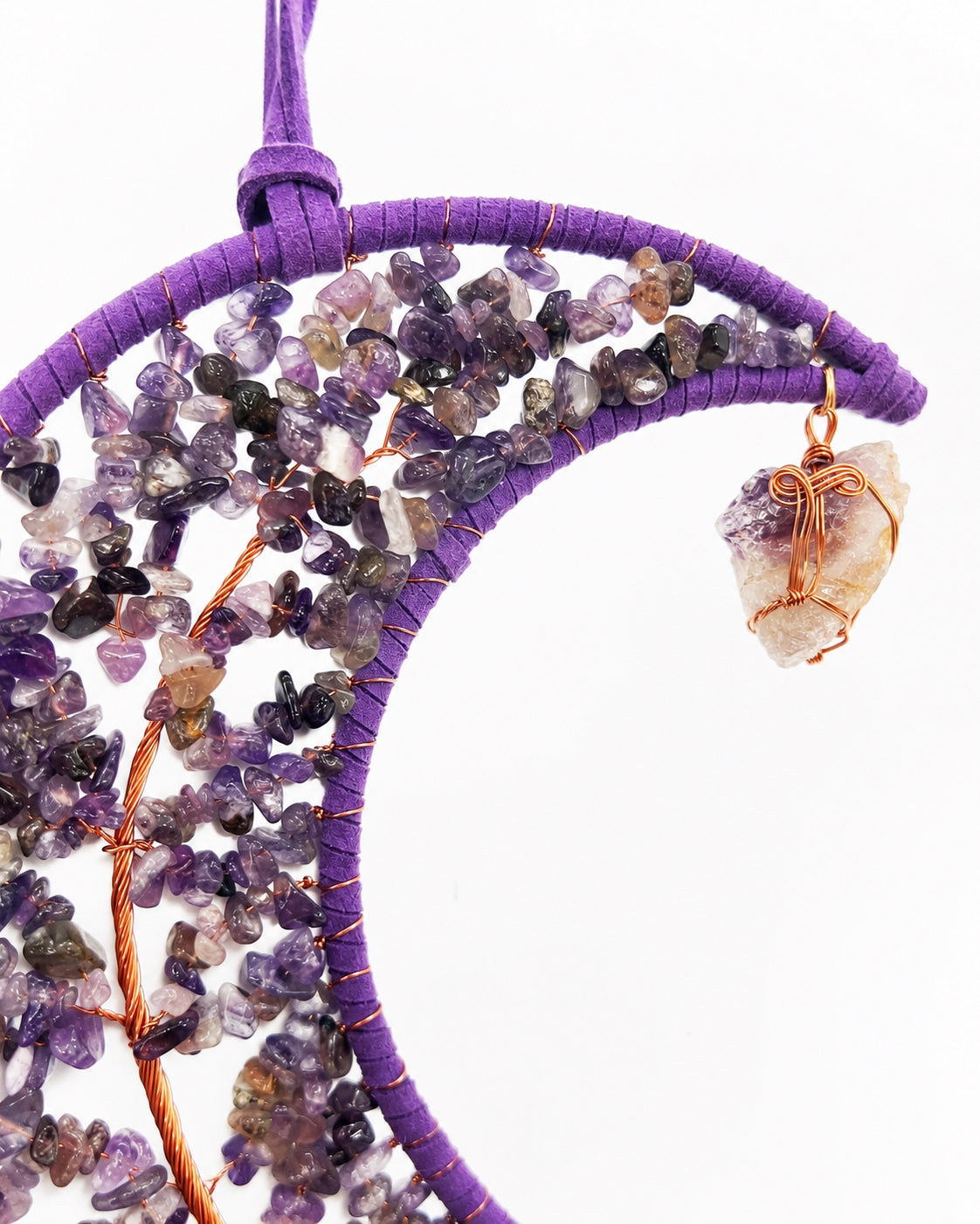 Close-up of a purple crescent moon dream catcher handcrafted with natural crystal chips, wire details and a small hanging pendant.