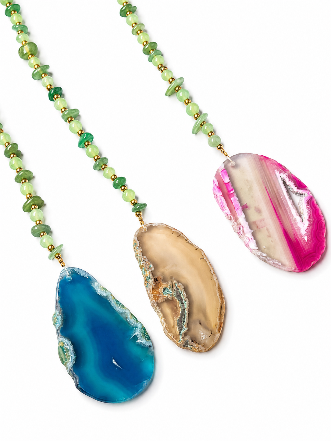 Three beaded hanging pendant with natural agate slice pendants, displayed on a clean white background. Feature green beads with gold spacers, one with a blue agate pendant, one with a tan agate pendant, and one with a pink and white agate pendant.