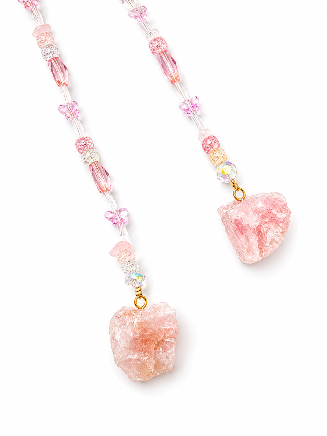 A beaded hanging pendant featuring light pink raw crystal pendants and small butterfly charms, strung with clear beads and iridescent accents on a white background.