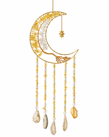 A gold crescent moon dream catcher ornament with hanging crystal strands and natural stone pendants, shown against a plain white background.