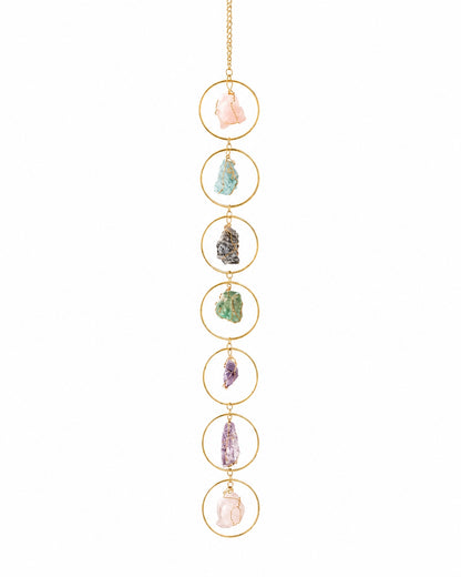 Full view of a colourful natural crystal hanging decoration with gold-toned circular frames on a clean white background.