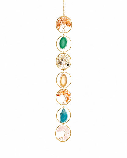 Full view of a colourful natural crystal tree of life hanging decoration with gold-toned circular frames on a white background.