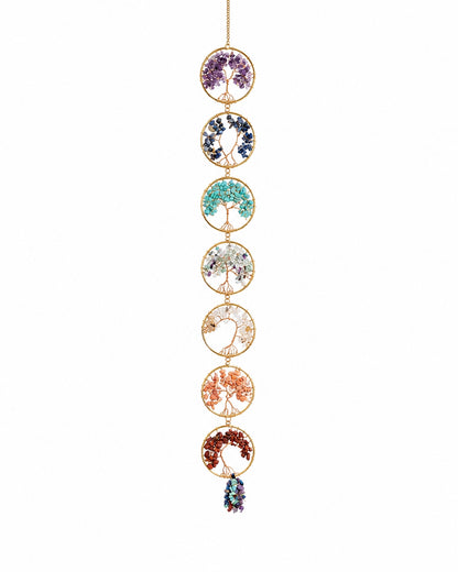 Colourful natural crystal tree of life hanging decoration on a white background.