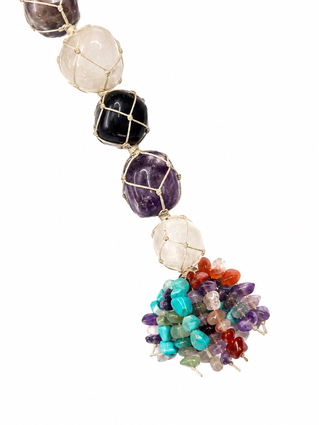 A beaded hanging pendant featuring large faceted gemstone beads in white, black, and purple, suspended in gold wire mesh, with a colorful tassel of small multicolored crystal chips at the bottom, shown against a plain white background.