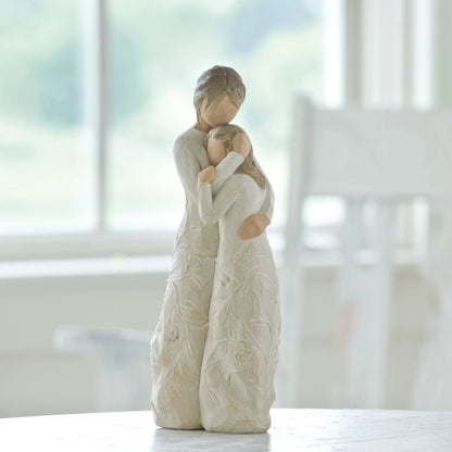 willow tree close to me Figure of standing older woman embracing younger girl, both in cream dresses carved with intertwined vines and leaves