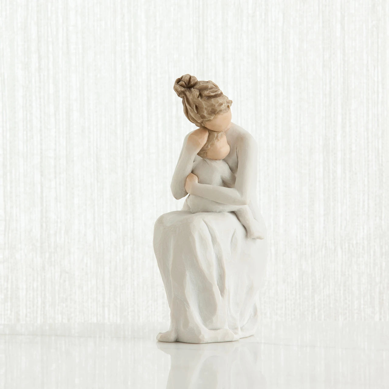 willow tree for always White ceramic figurine of a woman sitting on a white background