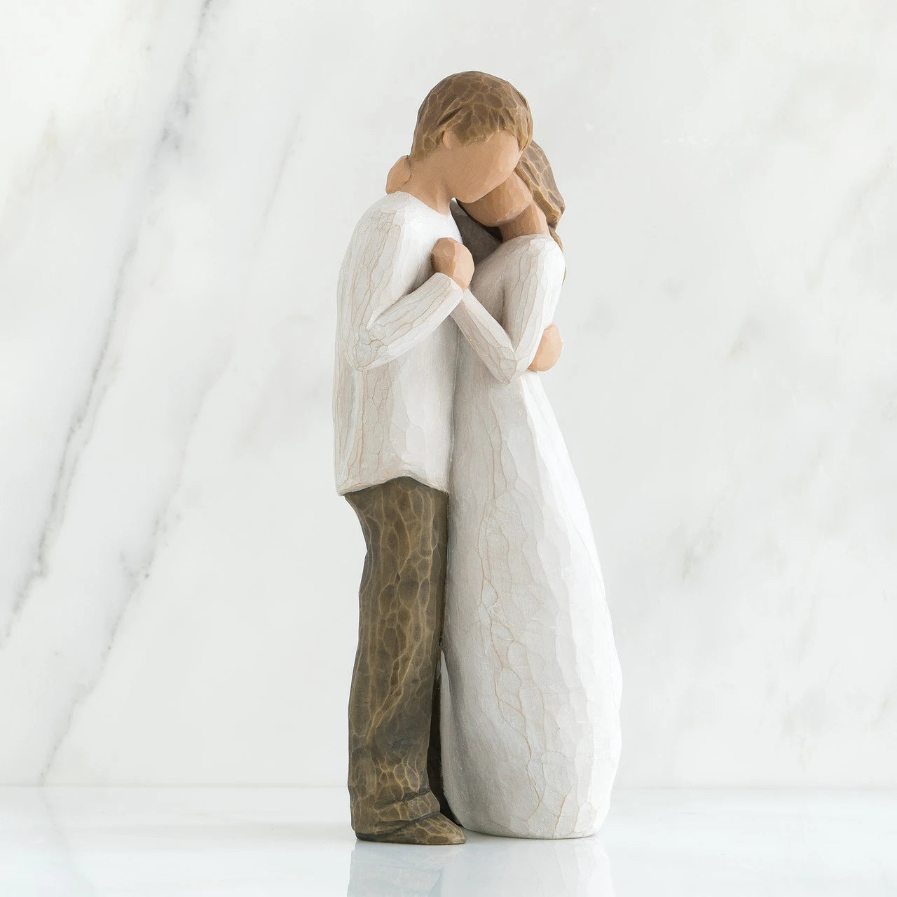 willow tree promise Statue of two people embracing on a white background